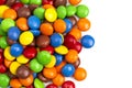 Pile of Rainbow Colored Candy Coated Chocolate Buttons Isolated on a White Background Royalty Free Stock Photo