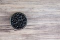 Pile of raw Black Beans in a bowl. black beans on wood background. Dry black beans in dark wooden bowl. Royalty Free Stock Photo