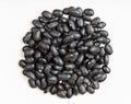 Pile of raw black turtle beans close up on gray