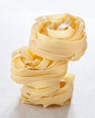 Pile of raw fettuccine nests