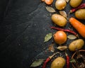 A pile of raw potatoes on a dark stone background. Preparation of soup or potato dishes.