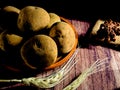 Pile of raw potatoes on dark wooden background. Preparation of potato soup or dish, perfect for advertising brochure background