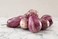 Pile of raw ripe eggplants on white marble table Royalty Free Stock Photo