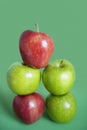 Pile of red and green apples over colored background Royalty Free Stock Photo