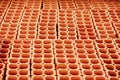 Pile of red hollow bricks with large holes forming lines in repeating geometric pattern Royalty Free Stock Photo