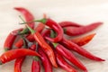 Pile of red hot chili pepper on wooden board. Cooking ingredient, closeup. Royalty Free Stock Photo