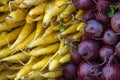 A pile of red Onions, and yellow carrots at a farmers market in Union Square New York City. Royalty Free Stock Photo