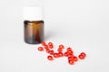 Pile of red pills on white table. Bottle Royalty Free Stock Photo