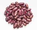 Pile of red spotted pinto beans close up on gray