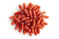 A pile of red supplement capsules isolation