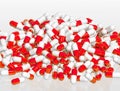 Pile of red and white pill capsules on white background, 3d rend Royalty Free Stock Photo