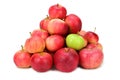 A pile of red and yellow apples. Among them is one green apple. Isolated on white background Royalty Free Stock Photo