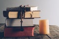 pile of religious books and christian cross