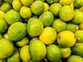 Pile of ripe green limes in a supermarket local market in Thailand Royalty Free Stock Photo