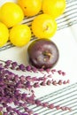 Pile of ripe juicy organic yellow red plums bouquet of lavender flowers on white cotton towel. Autumn fall Produce. Provence Royalty Free Stock Photo