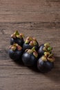 Ripe mangosteen, Queen of fruit on wooden background.