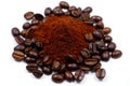 Pile of roasted coffee beans surrounding a mound of fresh coffee grounds Royalty Free Stock Photo