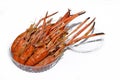 Pile of roasted giant freshwater prawns in clear plastic bowl.