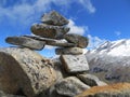 Pile of rocks balancing high up in the mountains, summit, mountain cairn, journey, path,