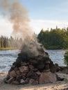 Pile of rocks on the shore of smoking hot Royalty Free Stock Photo