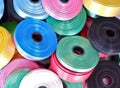 Pile of rolls of colorful colored ribbons. Stuff for luxurious wrapping gifts, any special occasion presents, birthday, Xmas.