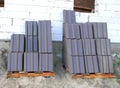 Pile of roof tiles ready to install on house roofing construction.