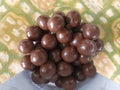 pile of round chocolates in a plastic bottle Royalty Free Stock Photo