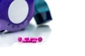 Pile of round pink small tablets pills on blurred background of asthma inhaler an accuhaler.