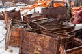 The pile of rusty metal boxes in the snow.