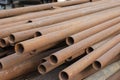 A pile of rusty metal pipes lies on the ground. Pipes for water and plumbing, closeup Royalty Free Stock Photo