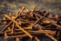 Pile of rusty used nails on the ground focus on the cottonwood s Royalty Free Stock Photo