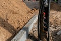 A pile of sand on the construction site. Repair of sidewalks and roadways in the city. Replacement and repair of lighting poles