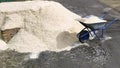 A pile of sawdust. The sawdust is piled up in a huge heap. Wood waste is transported by a garden cart