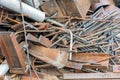 Pile of scrap metal with concrete steel and construction equipment