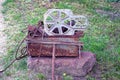 A pile of scrap metal from gray and brown rusty pieces of iron on a stone