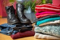 Pile of second hand clothing and shoes with computer on floor Royalty Free Stock Photo