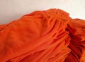 A pile of several orange drawstring pants