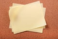 Pile several untidy yellow post notes cork notice board background