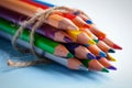 Pile of sharp coloured drawing pencils on table