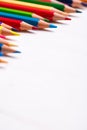 Pile of sharp coloured drawing pencils on table