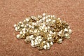 A pile of thumbtacks on a cork board. Royalty Free Stock Photo
