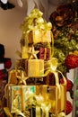 Pile of shiny gift boxes decorated in Christmas tree with Christmas ornament decorations Royalty Free Stock Photo