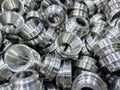 Pile of shiny metal aerospace parts production - close-up with selective focus for full frame industrial background