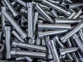 pile of shiny steel tubes after cnc turning operations - abstract full frame indistrial background