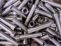 pile of shiny steel tubes after cnc turning operations - abstract full frame indistrial background