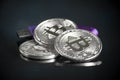 Pile of silver bitcoin cryptocurrency coins with purple digital Royalty Free Stock Photo