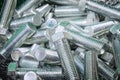 A pile of silver bolts. Stainless steel bolts, close-up. Construction fixture. Fasteners made of steel Royalty Free Stock Photo