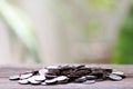 Pile silver coin on a wood floor.