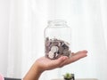 Pile of silver coins,Piggy bank Money on hand,Background,Business,White