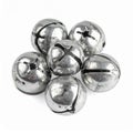 Pile of Silver Jingle Bells on White Background for Christmas Decor Royalty Free Stock Photo